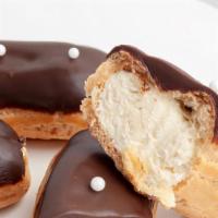 Vanilla Eclair  · Choux pastry filled with Vanilla pastry cream. Topped with dark chocolate glaze and white/da...