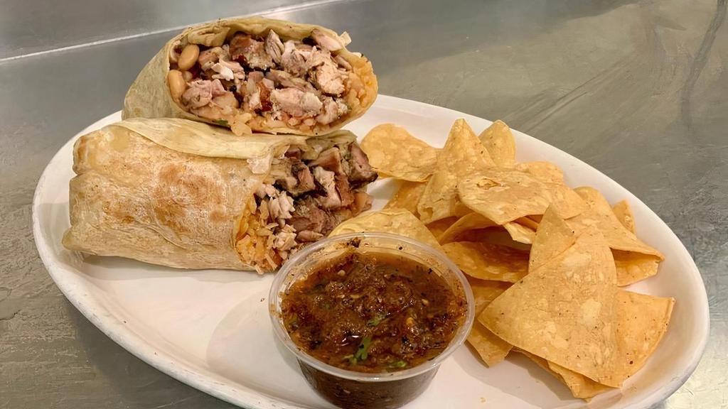 Andale Supremo Burrito · Choice of filling, beans, rice, guac, crema, cheese, salsa, tortilla chips and roasted tomato salsa