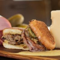 The Cuban · Citrus braised pork, ham, Swiss cheese, pickles, and caramelized onion mustard.  Pressed on ...