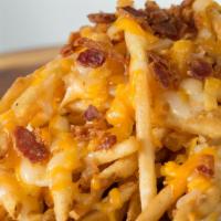 Cheese Fries · A shareable portion of fries, Monterey jack & cheddar cheese, queso, chopped bacon & grilled...