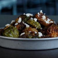 Brussels Sprouts · Roasted brussels sprouts tossed in ancho lime vinaigrette and topped with queso fresco.