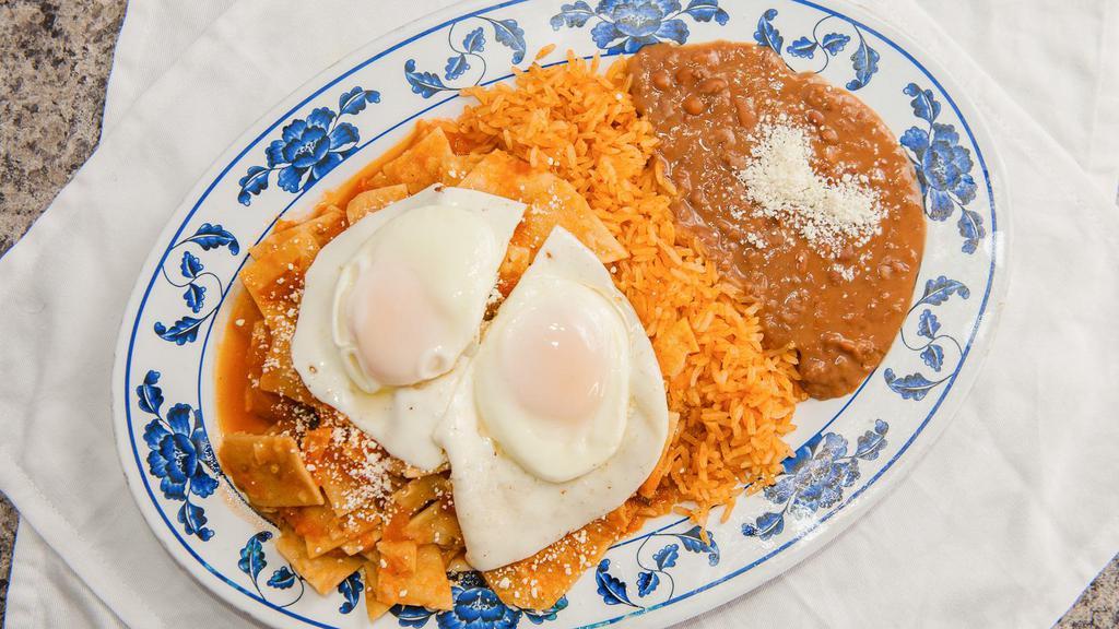 Chilaquiles · Fried tortilla pieces sautéed in your choice of sauce with your choice of style two eggs accompanied with Mexican rice and refried beans.