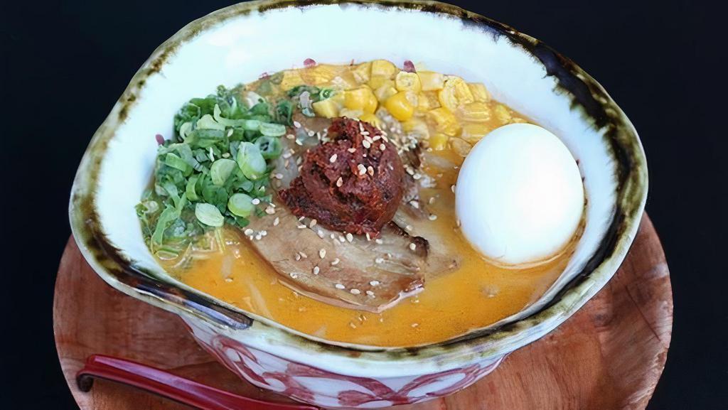 SPICY MISO RAMEN · Miso Ramen with creamy Chicen Broth topped with original spicy paste. Medium thick curly noodle, Chicken Broth, chashu pork, spicy paste, bean sprouts, green onion, corn and seasoned boiled egg.