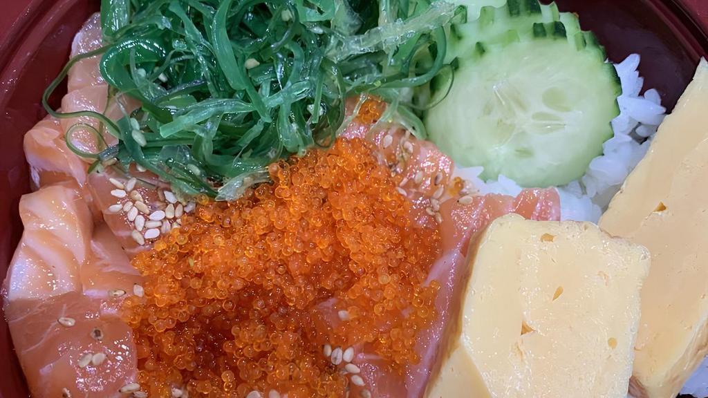 Poke Bowl · Raw salmon mix sauce over rice with tamago cucumber, tobiko, sesame, scallion, seaweed salad.