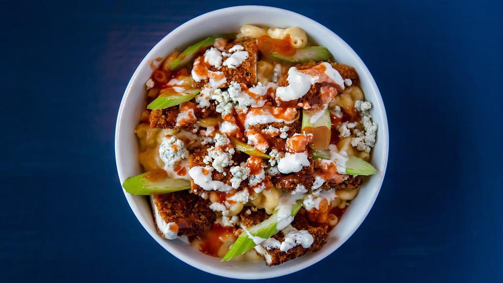 Buffalo Chicken Mac & Cheese · Crispy panko-crusted parmesan chicken, blue cheese crumbles, celery, frank’s buffalo sauce, homemade ranch atop our classic mac & cheese.