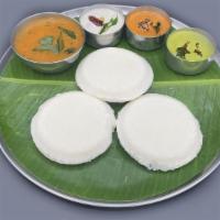 Thatte Idly · Three pieces of thatte idly. Three pieces large flat idlies served with sambar and chutneys.