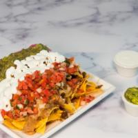Super Nachos · Any meat, tortilla chips, beans, melted jack cheese, sour cream, guacamole and salsa.