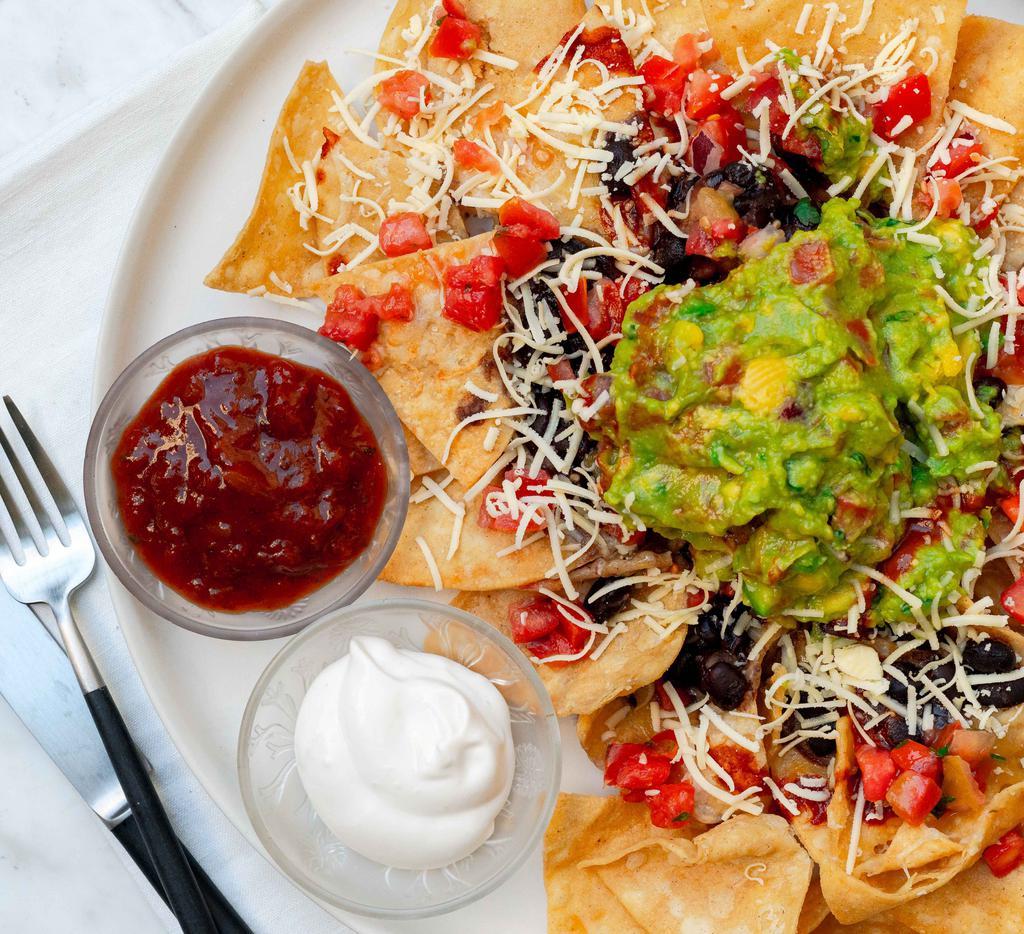 Vegetarian Nachos · Tortilla chips, beans, melted jack cheese, lettuce, sour cream, guacamole and salsa.
