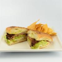 Torta De Milanesa · Toasted Mexican bread with refried beans, cheese, sour cream, tomato, lettuce and guacamole.