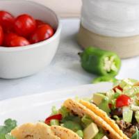 Super Veggie Taco · Corn tortillas, cheese, beans, rice, lettuce, guacamole, sour cream and salsa.