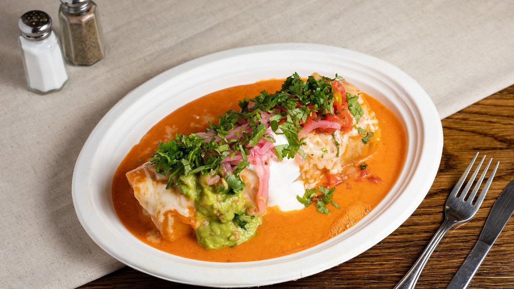 Special Mojado Wet Burrito · Any meat, rice, beans, topped with enchilada sauce, melted cheese, guacamole, sour cream and salsa.