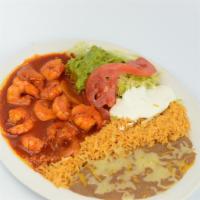 Camarones A La Diabla (Spicy Shrimp) · Prawns, rice, beans, guacamole, sour cream, salad and tortillas.