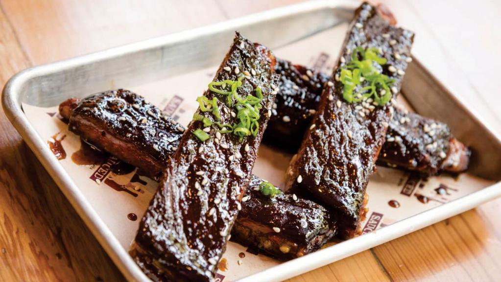 Sticky Ribs · smoked and deep fried spare ribs tossed . in a house made asian sticky sauce with . toasted sesame seed and green onion garnish