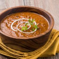 Dal Makhani (DM) · Black Lentils cooked with Herbs & Spices, then sautéed in Butter & garnished with Fresh Cori...