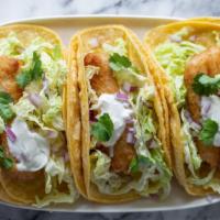 Pescado (Tilapia) Taco · Mexican-style Taco prepared with Tilapia, and topped with cilantro, diced onions, and hot sa...