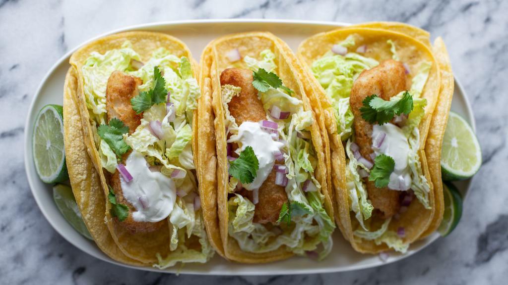 Pescado (Tilapia) Taco · Mexican-style Taco prepared with Tilapia, and topped with cilantro, diced onions, and hot sauce.