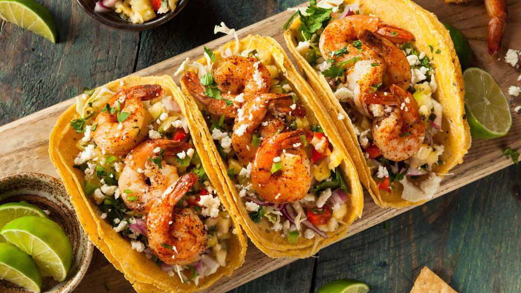 Camaron (Shrimp) Taco · Mexican-style Taco prepared with Shrimp, and topped with cilantro, diced onions, and hot sauce.