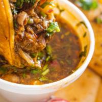 Taco de Birria · Mexican-style Super Taco prepared with Birria style Beef, and topped with cilantro, diced on...