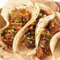 Nashville Hot Chicken Tacos · nashville hot oil, jalapeno sweet heat slaw, hot honey, pluck sauce, green onions