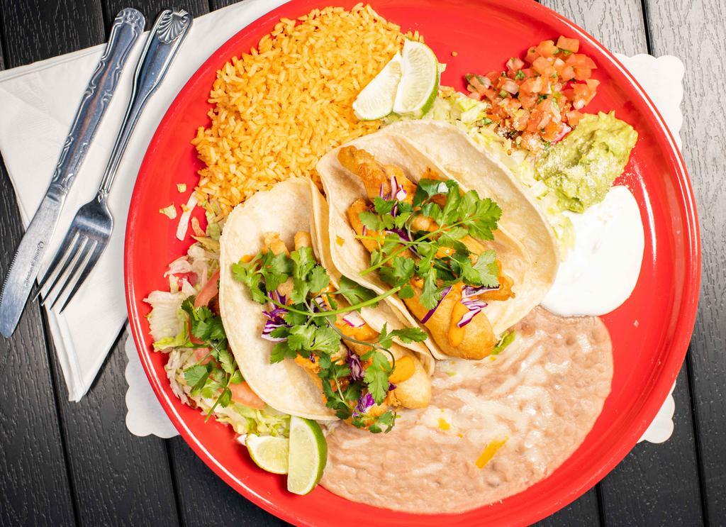 12. Baja Style Tacos · Deep fried Tilapia fish served two corn soft tortillas topped with house lime sauce, shredded cabbage and guacamole sour cream and diced pico de gallo on the side.