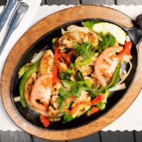 21. Fajitas · Sizzling meat grilled with sliced onions, bell peppers and zucchini served with a side of ri...