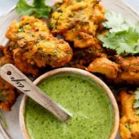 Mixed Veggie Pakoras · Crispy appetizers filled with mixed vegetables. Served with delicious tamarin and mint sauce.