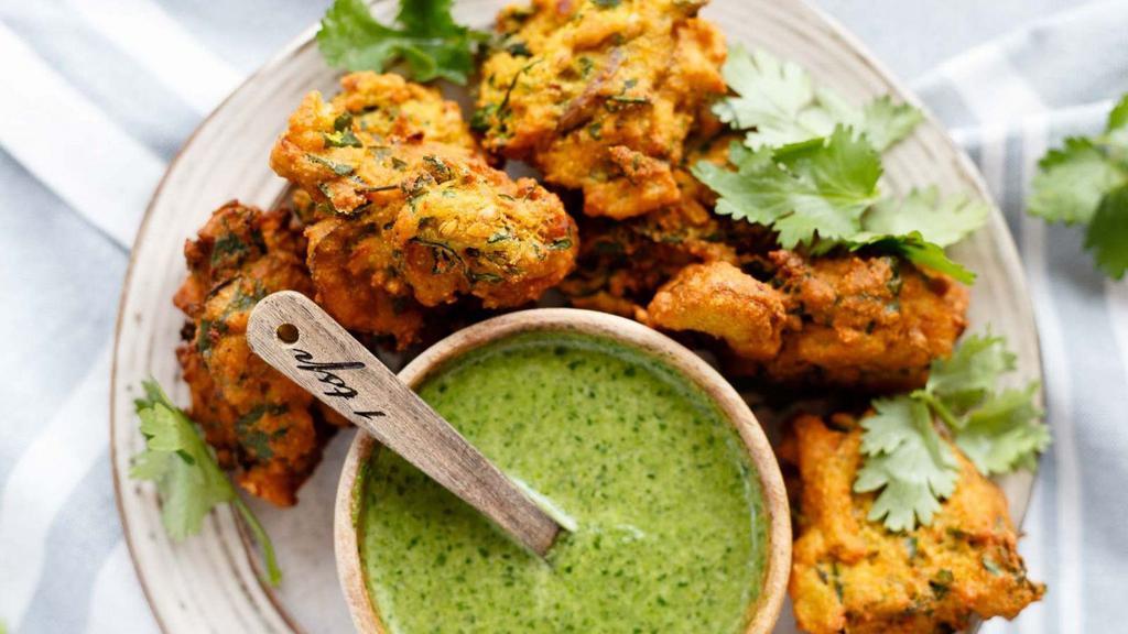 Mixed Veggie Pakoras-8pcs · Crispy appetizers filled with mixed vegetables. Served with delicious tamarin and mint sauce.
