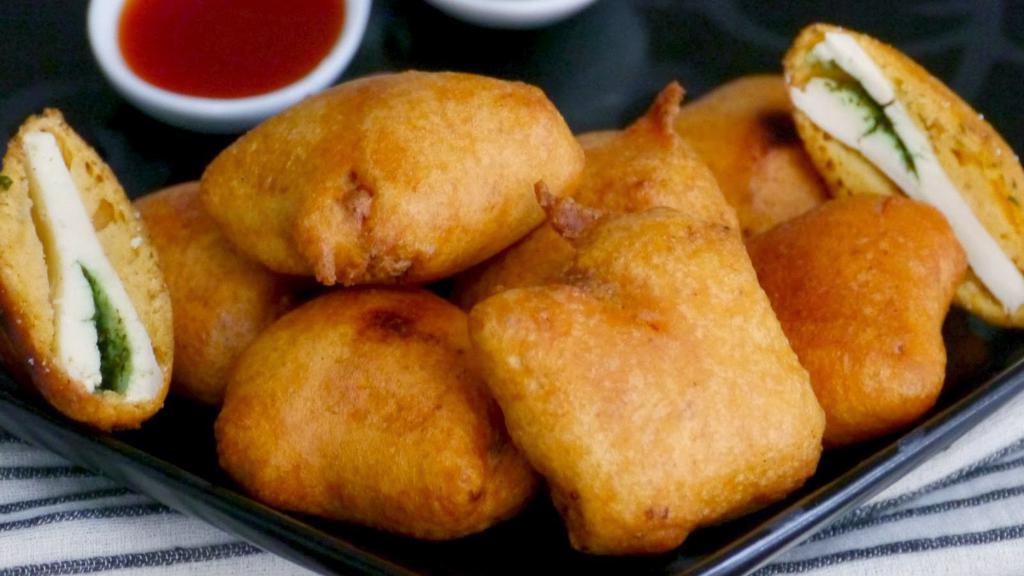 Paneer Pakoras · Marinated paneer (Indian cheese) dipped in a batter and fried making a crispy, mouthwatering appetizer. Crispy outside and soft inside, these pakoras are addicting!