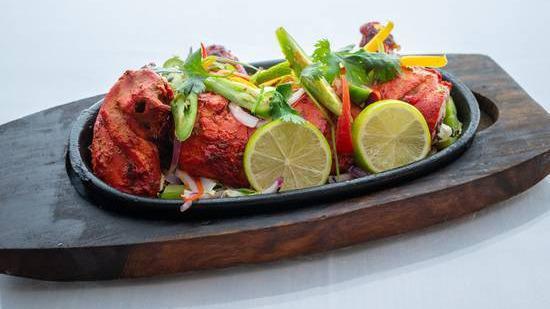 Full Tandoori Chicken · Four pieces of Tandoori Chicken marinated in yogurt and Indian spices then roasted in a hot tandoor oven clay.