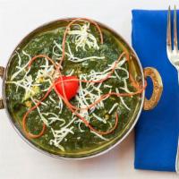Saag Paneer-Chef's Special · Spinach leaves cooked with cubes of homemade cottage cheese with Indian spices and creamy sa...