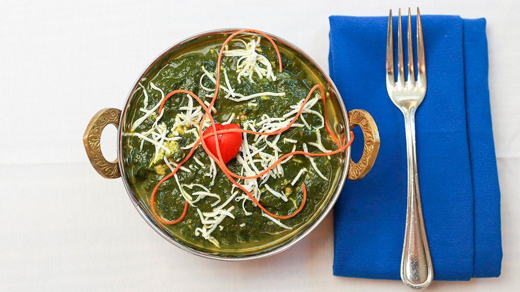 Saag Paneer-Chef's Special · Spinach leaves cooked with cubes of homemade cottage cheese with Indian spices and creamy sauce.