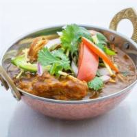 Chicken Curry · Home style cooked chicken curry with Indian spices and tomato and onion based gravy.