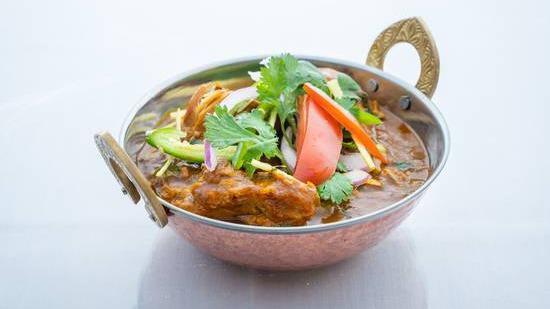 Fish Curry · Fresh tilapia fish submerged in tomato based gravy with Indian spices and green peas.