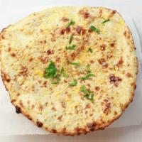 Cheese Naan · Homemade cheese-stuffed white bread baked in a clay oven.