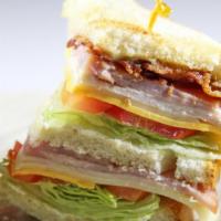 Classic Club Sandwich · Turkey, ham, thick-cut bacon, mayo, mustard, lettuce, and tomato.