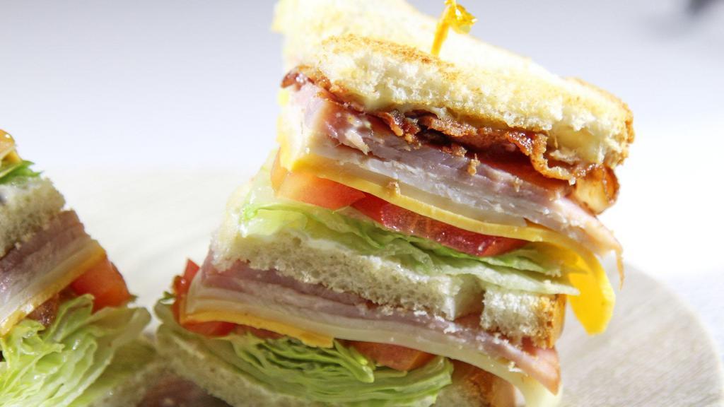 Classic Club Sandwich · Turkey, ham, thick-cut bacon, mayo, mustard, lettuce, and tomato.
