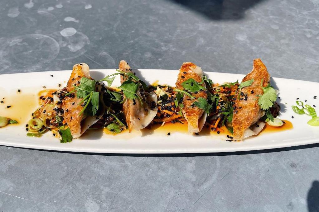 Ahi Tuna Potstickers · Four steamed potstickers loaded with ahi, ginger, garlic & scallions, house-made unagi sauce, soy chili slaw