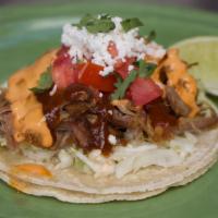 Carnitas Taco · Coleman ranch pulled pork carnitas, chipotle aioli, spicy bbq sauce, cilantro, salsa fresca ...