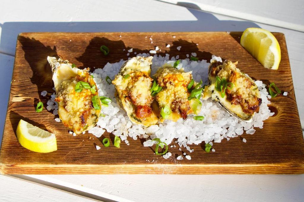 Baked Oysters Bubba · Four local oysters baked with spinach, bacon & our Pernod-spiked creole Rockefeller sauce