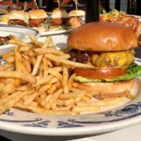 Clover Burger · Six-ounce patty of Angus beef, American cheese, lettuce, tomato, Nola secret sauce, tomato b...
