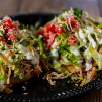 Sope · Corn masa dough, deep fried to perfection. Topped with Beans, Cheese, your Choice of Meat, S...