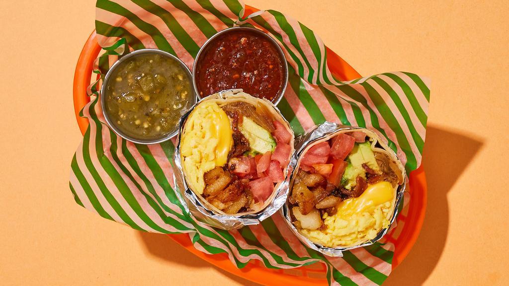 Millennial Avocado Breakfast Burrito · Two scrambled eggs with bacon, crispy home fries, melted cheese, avocado, tomato, and caramelized onions wrapped up in a flour tortilla.