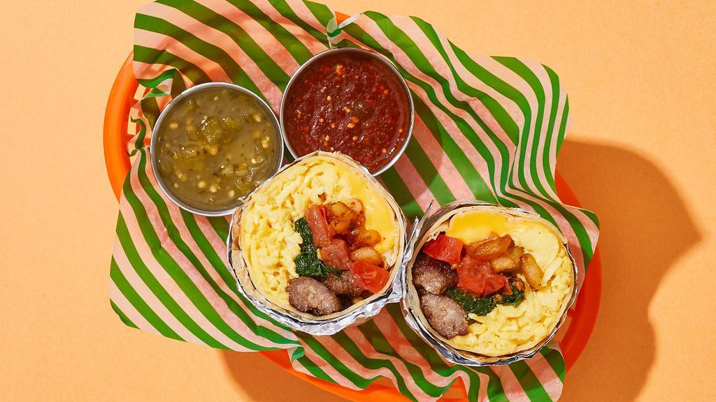 Comfy Tomato and Spinach Breakfast Burrito · Two scrambled eggs with delicious breakfast sausage, crispy home fries, melted cheese, tomatoes, and spinach wrapped up in a flour tortilla.