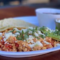 EL YUCATECO · Scrambled eggs with tomatoes and onions, served with side  refried black beans, sour cream, ...