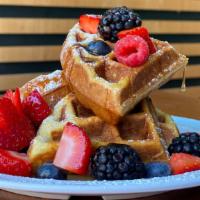 WAFFLES · Homemade waffles served with fruit,  maple syrup and butter.