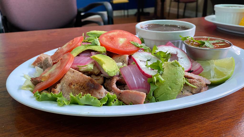 POC-CHUC (MAYAN CLASSIC) · Gilled pork marinated in beer and sour orange juice, served with refried black beans, cabbage, avocado, pickled red onions and homemade tortillas.