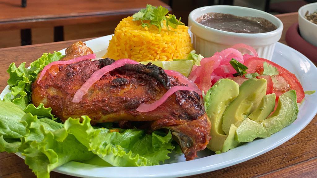 POLLO ASADO · Baked chicken rubbed in anatto seasoning, served with rice, black beans, side salad and handmade tortillas.
