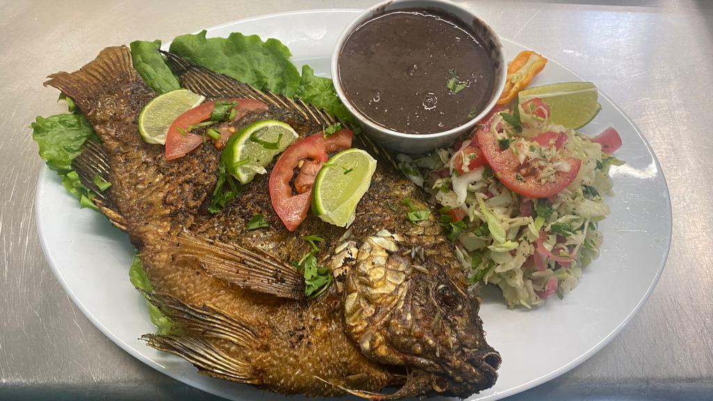 PESCADO FRITO · whole fried fish, served with rice and black refried beans and handmade tortillas