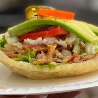 SALBUTES · Lightly fried handmade masa tortilla, no filling. Topped with lettuce, pickled red onions, c...