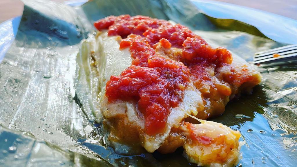 MAYAN TAMALES · chicken tamales wrapped In banana leaves, stuffed with house adobo, steamed and served tip homemade tomato salsa